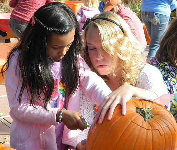 Learning how to carve a pumpkin with Pumpkin Masters tools. Photo credit: Los Alamos Arts Council.
